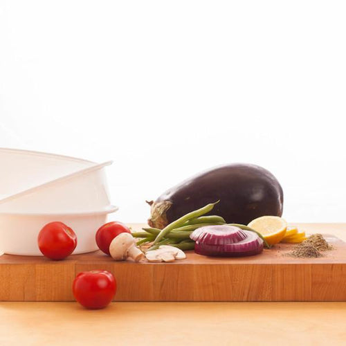 Eggplant tomato onion and other vegetables on a cutting board Eat Smart RVA meal delivery service